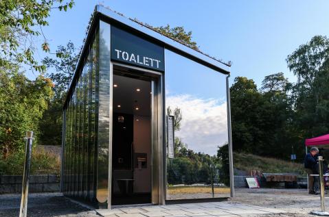 JCDecaux automatic public restroom in Sundbyberg equipped with a dedicated dog bowl and drinking fountain for park visitors