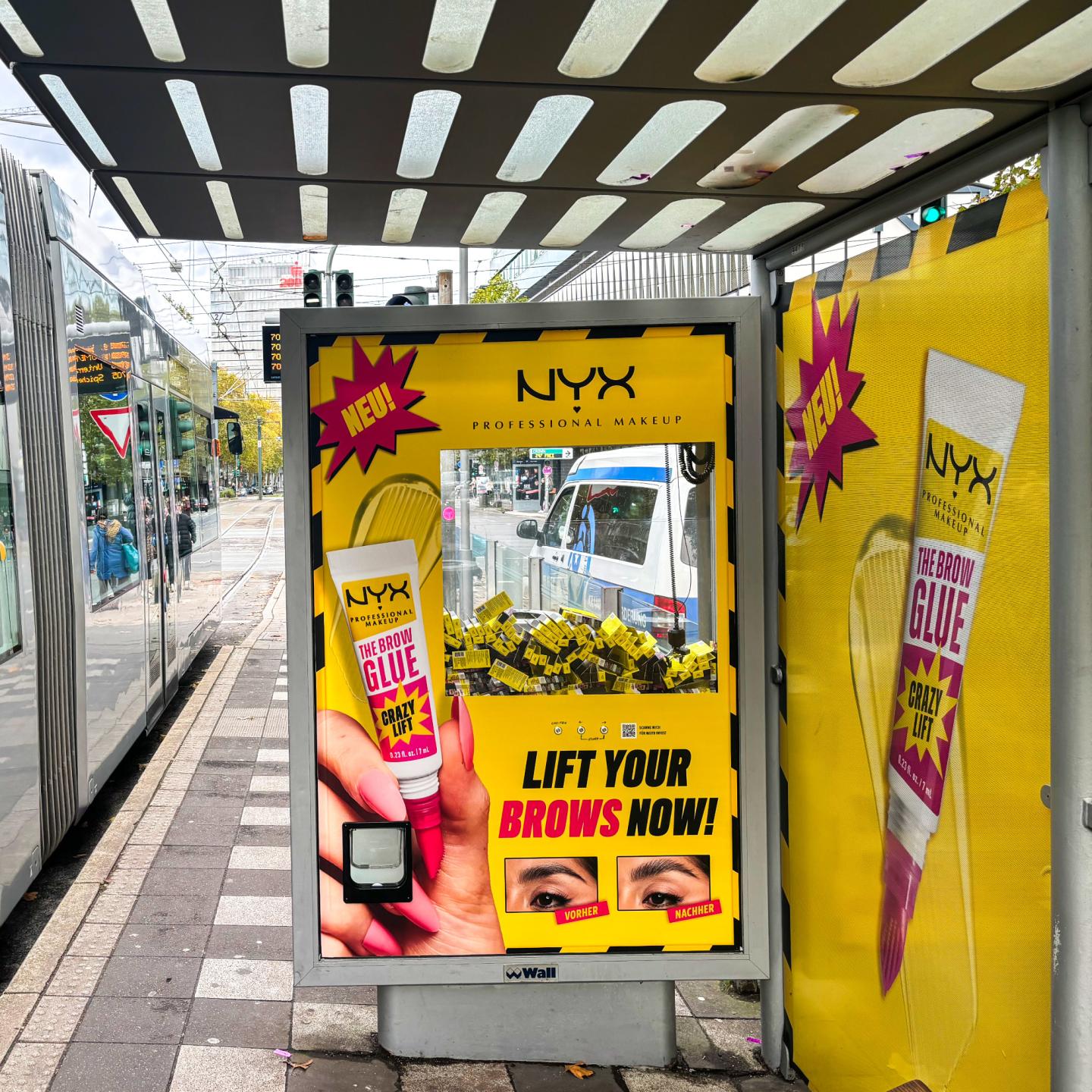 Interactive NYX and WallDecaux arcade-style tram shelter campaign with claw machine