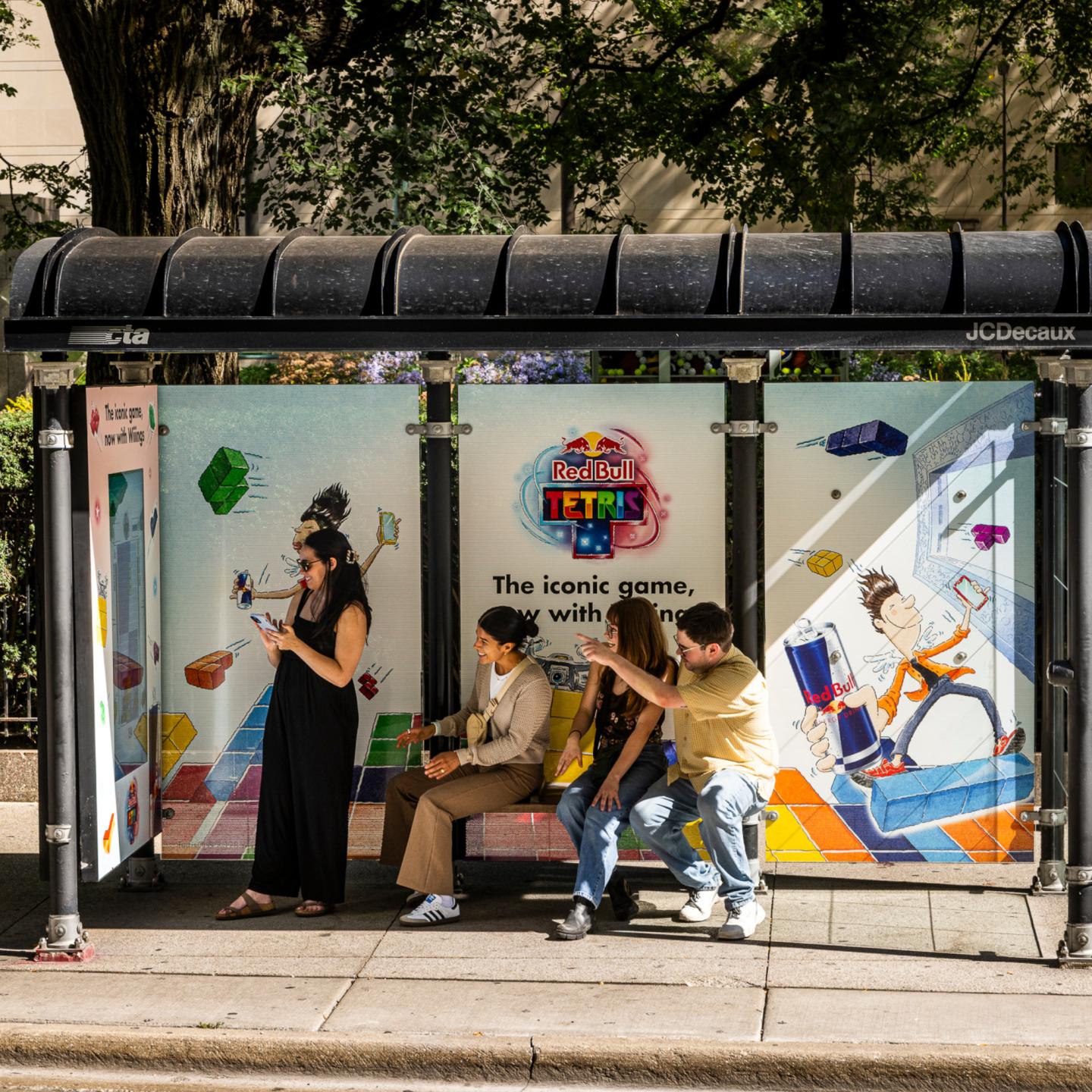 Passengers playing Tetris with Redbull Campaign on a JCDecaux bus shelter
