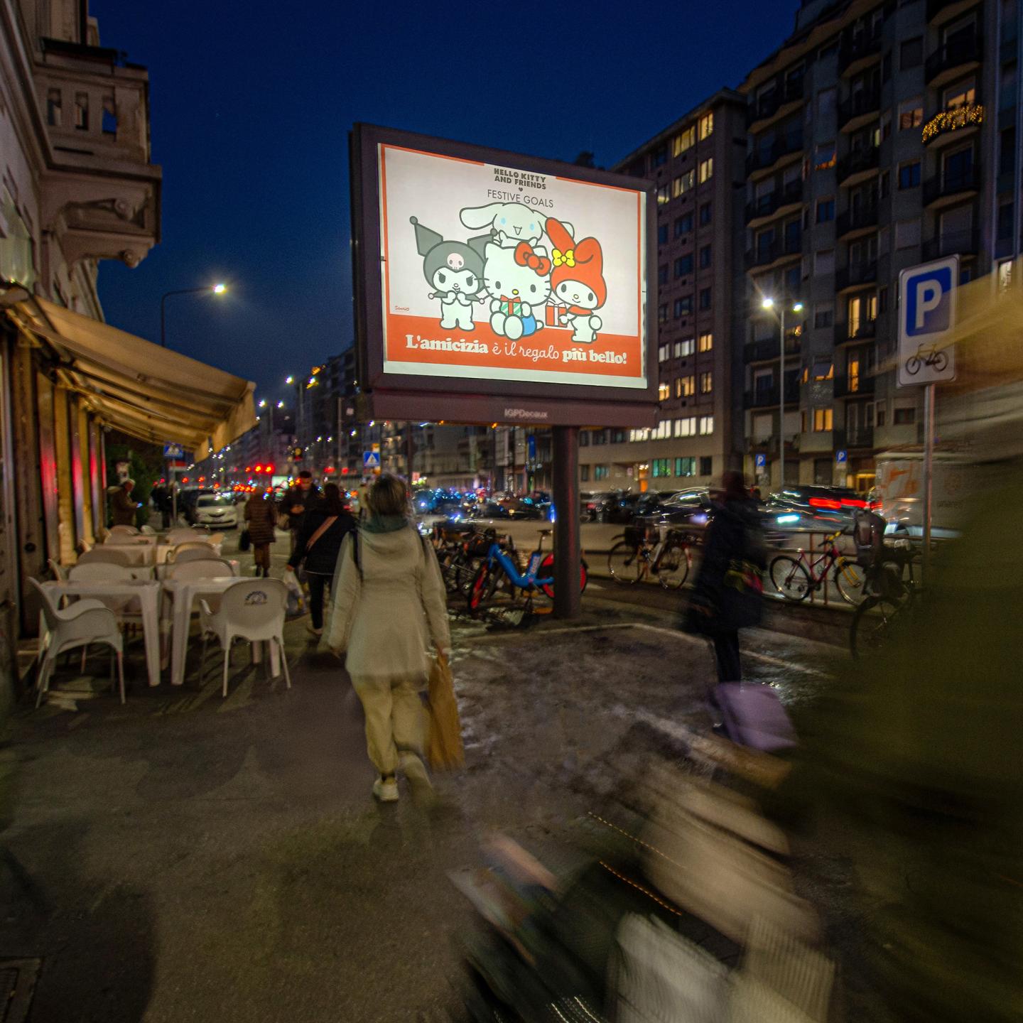 Festive Hello Kitty out‑of‑home campaign in Milan spreading kindness and positivity across JCDecaux bus shelters and screens.