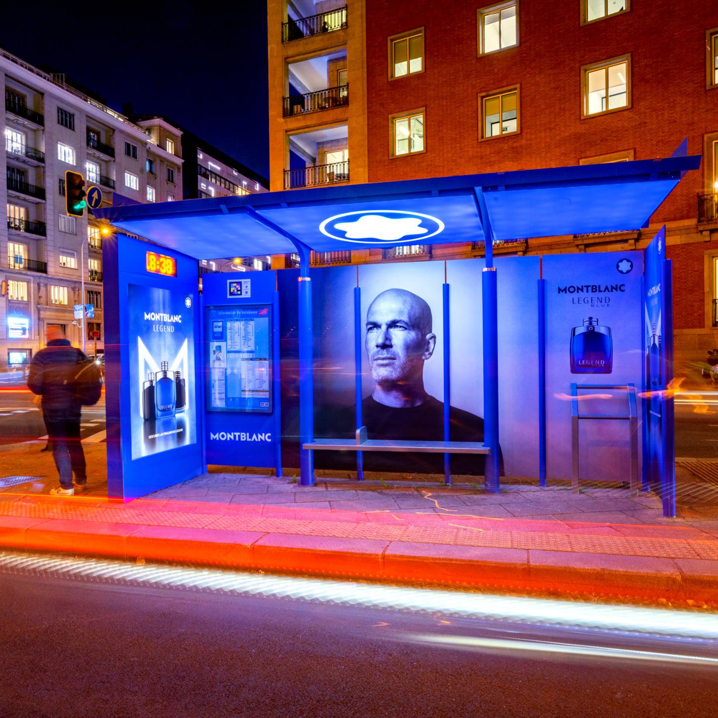 Inside view of a JCDecaux bus shelter wrapped in Montblanc Legend visuals with a glowing logo in the ceiling