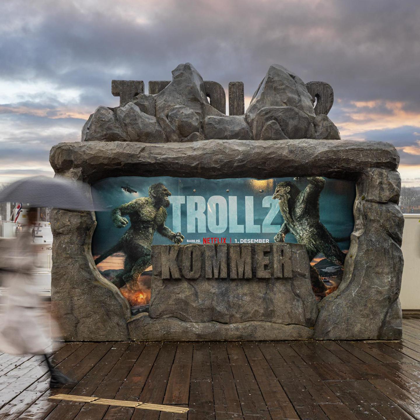 Urban installation in Oslo where a JCDecaux stony bus shelter slowly reveals the “Troll 2” artwork