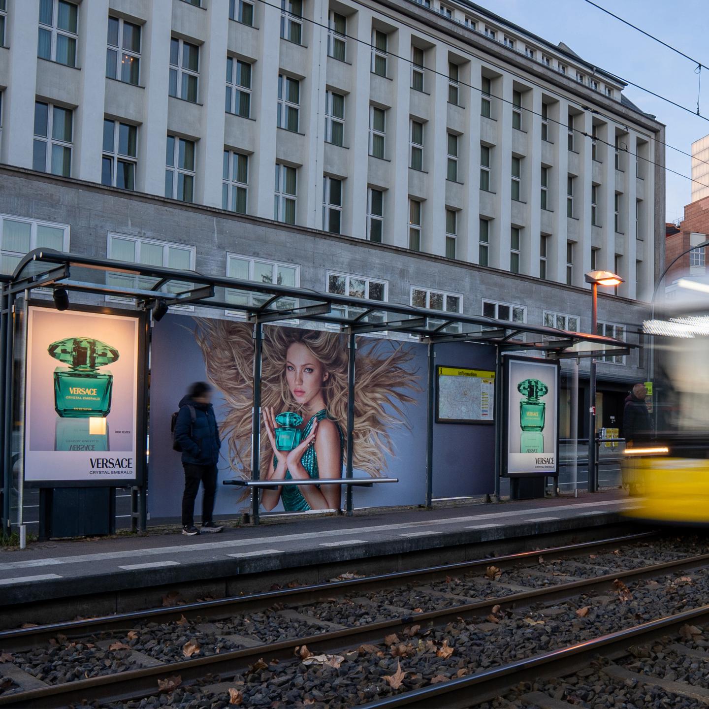 Berlin bus shelter transformed into a full Versace Crystal Emerald showcase, with green visuals and a fragrance sampling device.