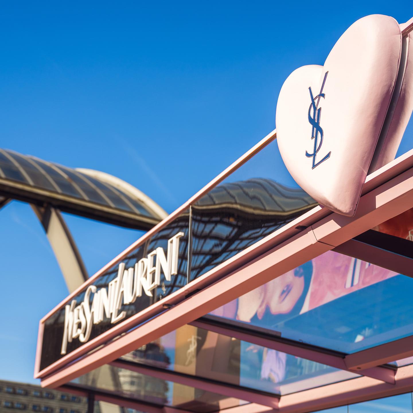 View of the YSL Lovenude urban takeover in Amsterdam, showing the synergy between street furniture and branded water transport.