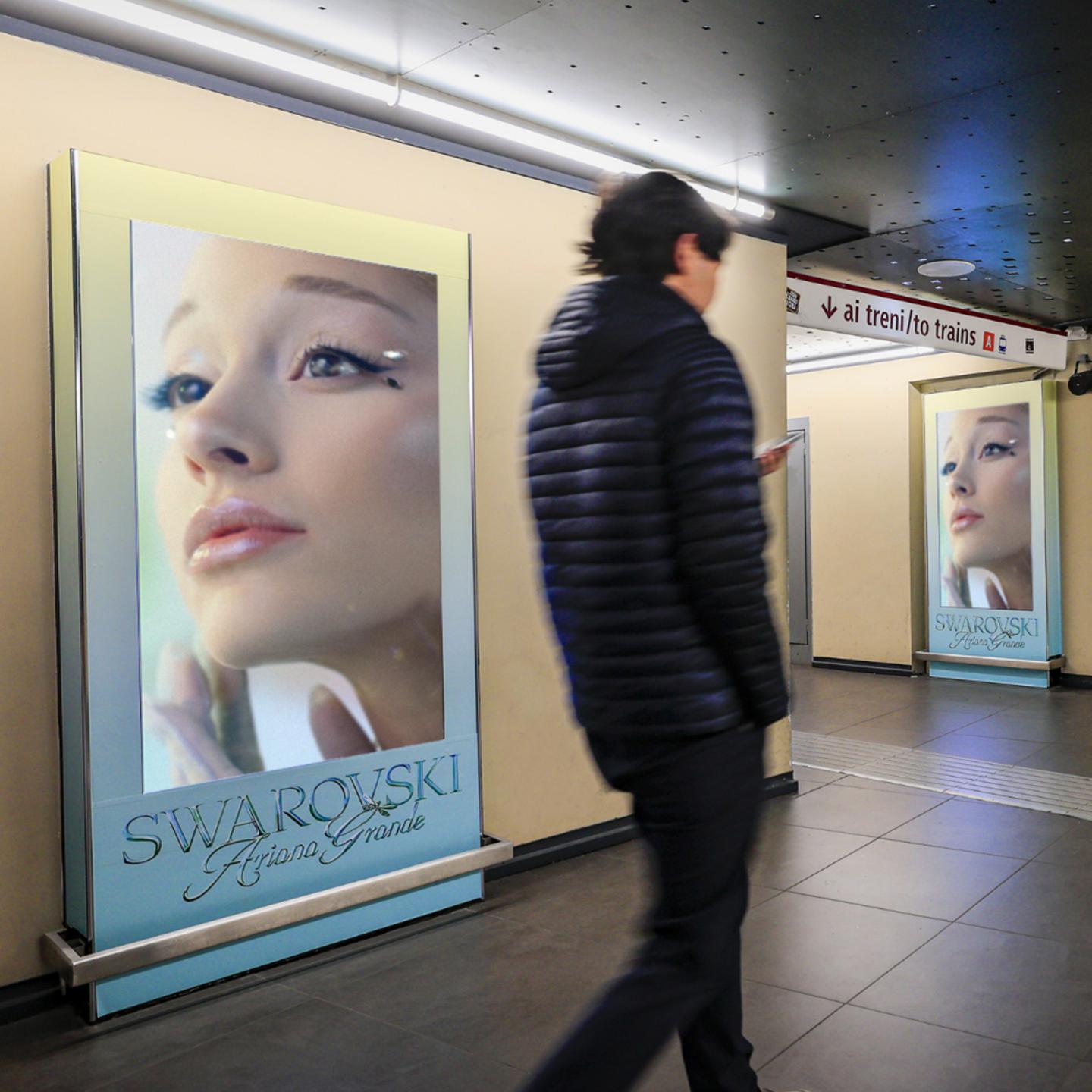 A strategic OOH advertising placement by IGPDecaux showcasing the Ariana Grande x Swarovski branding amidst a shower of crystals at Spagna station