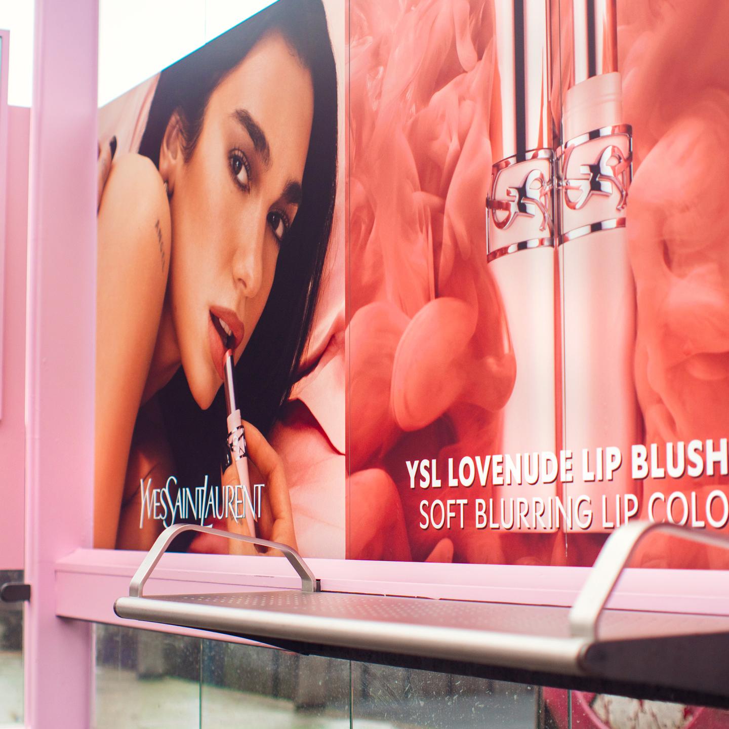 Large-scale out-of-home advertising display by JCDecaux Nederlands featuring the YSL Lovenude campaign at Amsterdam Centraal station.