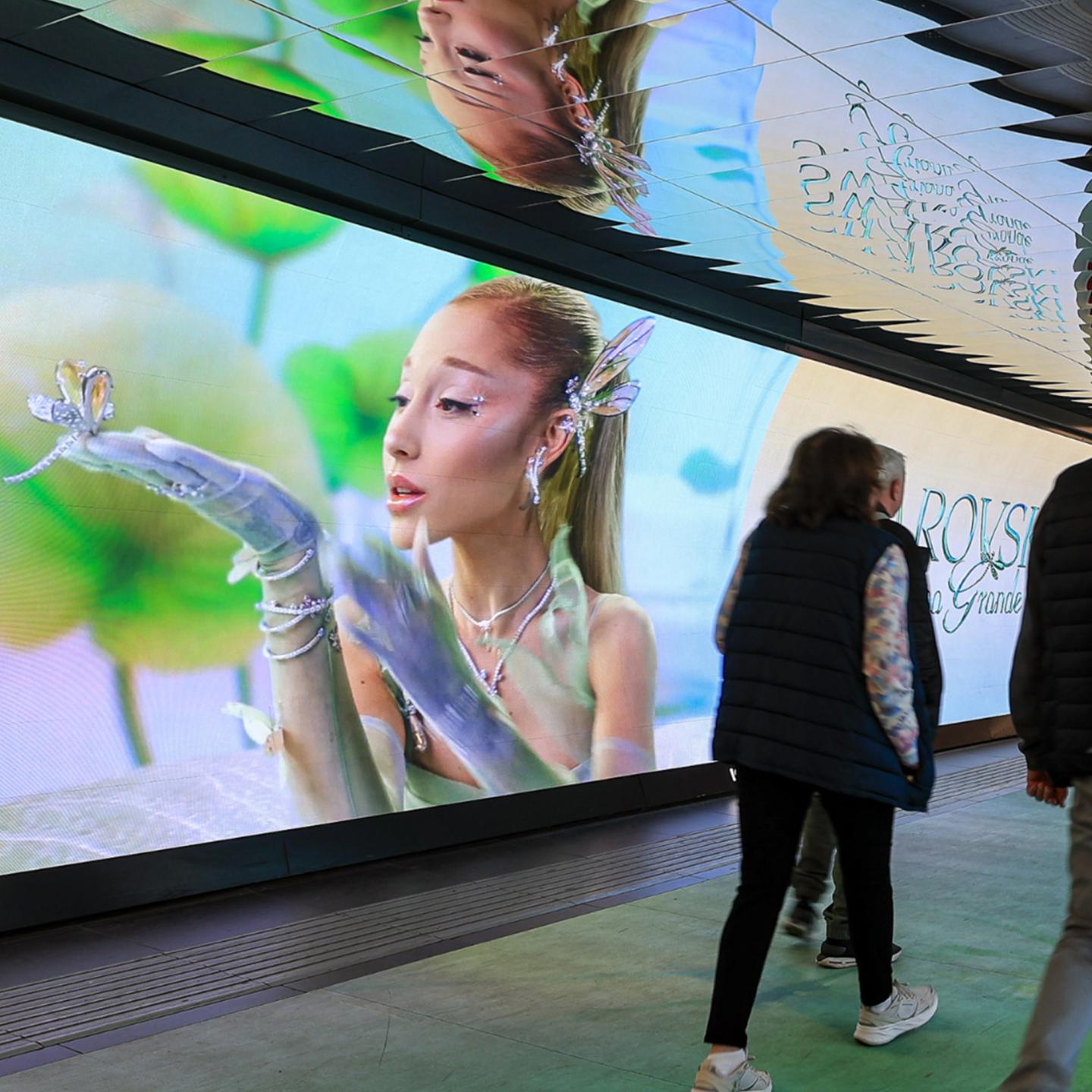 Close-up of a monumental crystal flower installation by Swarovski, reflecting light within the Rome underground