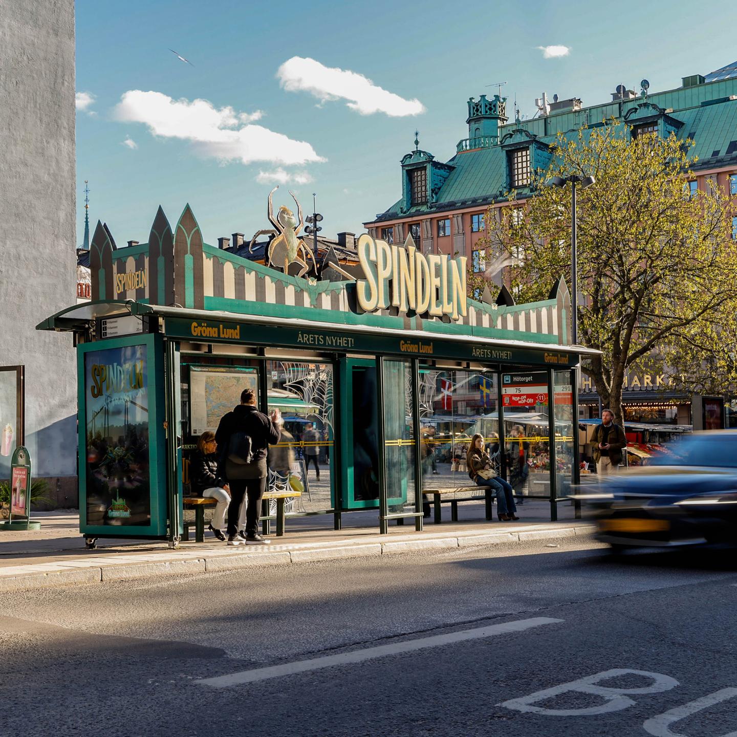 Close-up of giant, realistic cobwebs covering a JCDecaux bus stop for the promotion of Gröna Lund's Spindeln attraction.