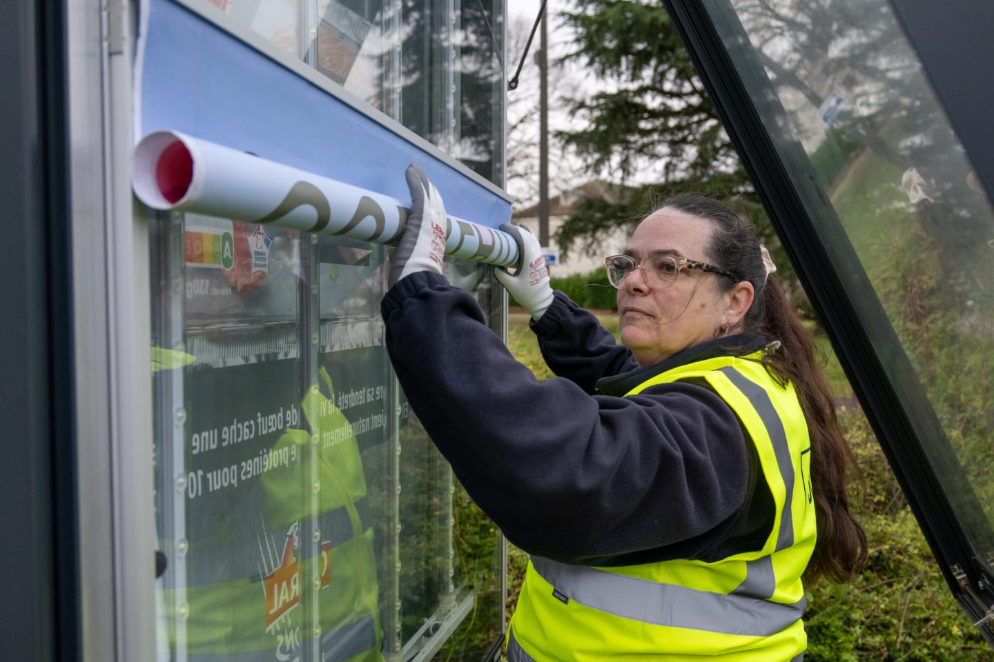 JCDecaux employee posting a campaign
