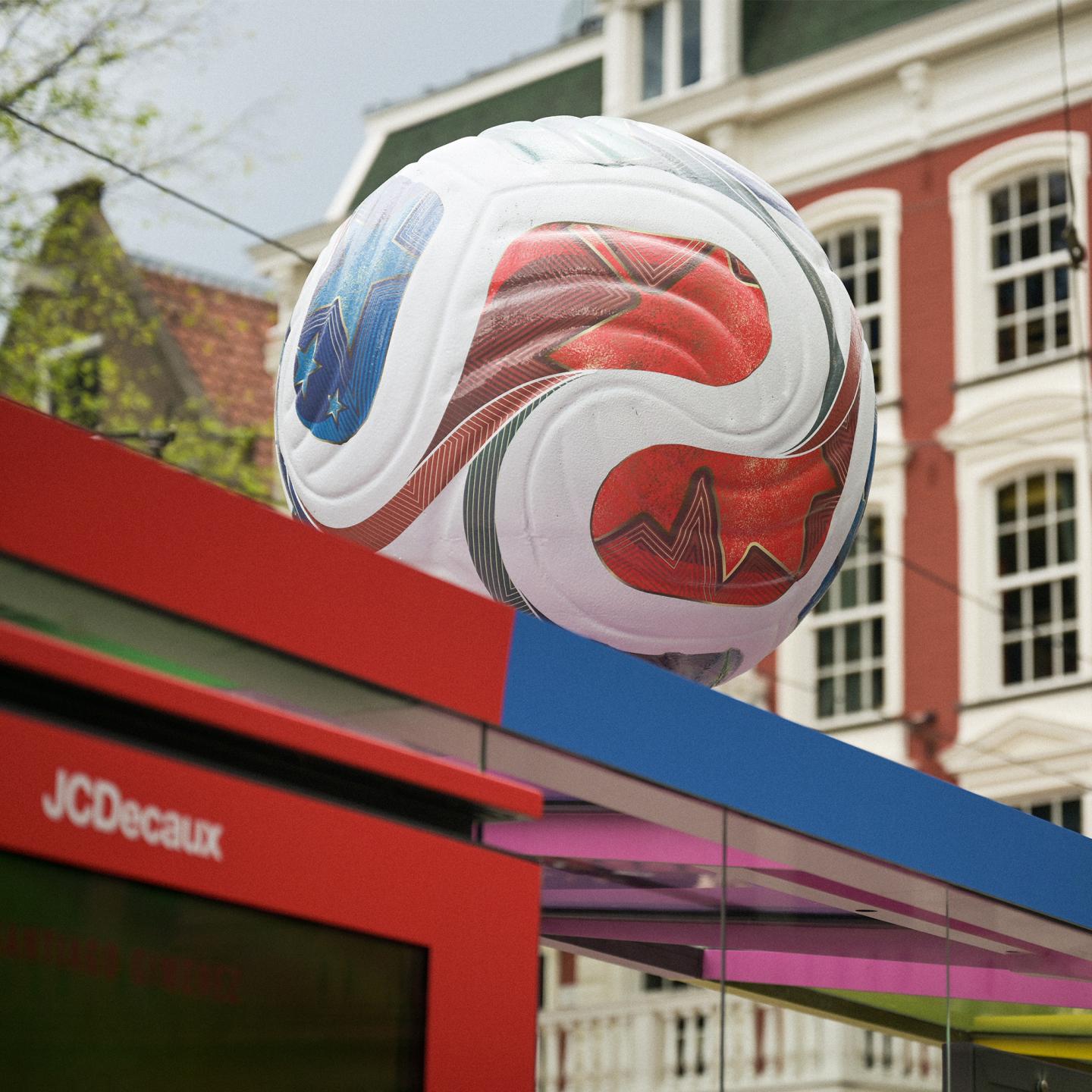 Adidas and JCDecaux World Cup campaign at an Amsterdam bus shelter, showing transformed benches as storage crates and the 3D Trionda ball above.