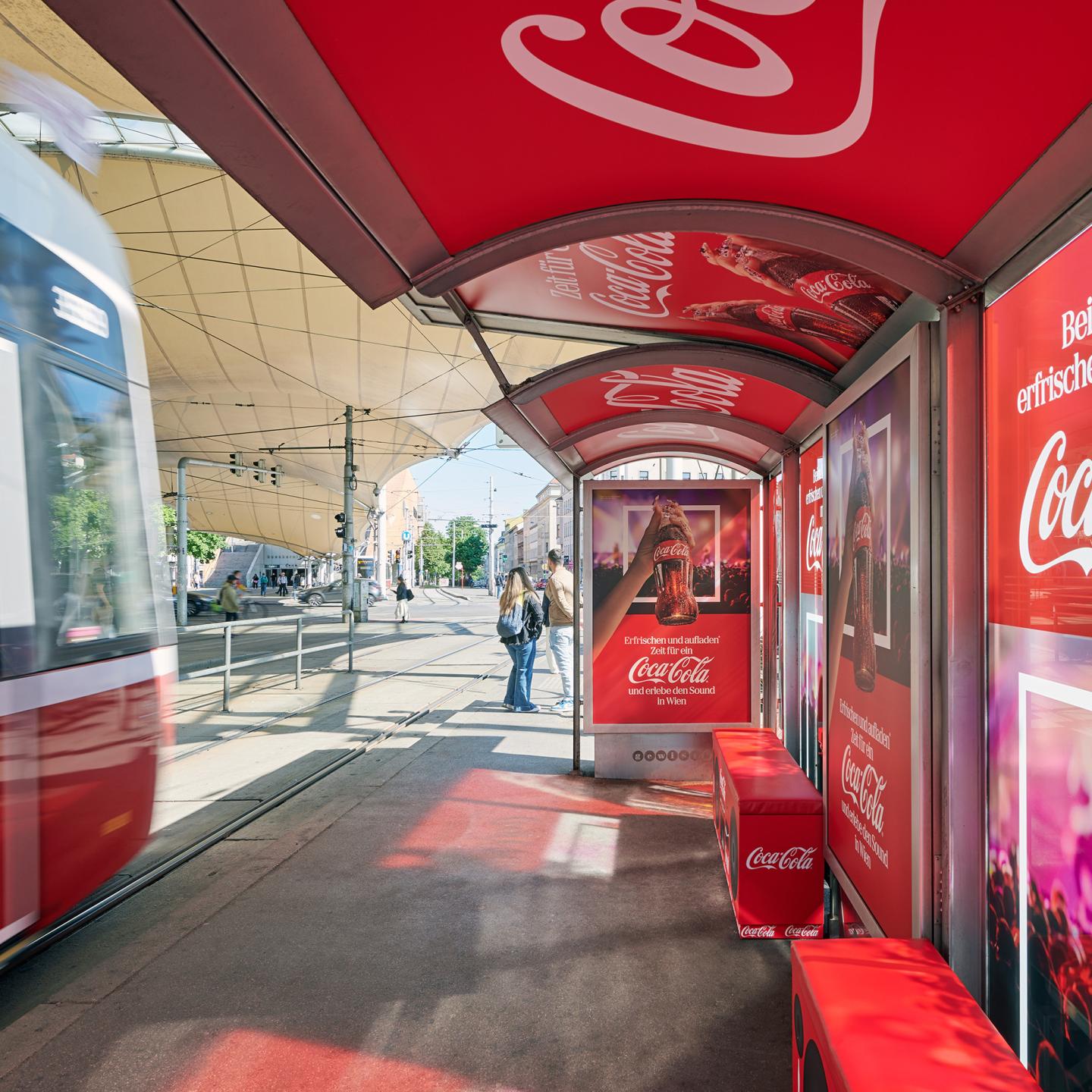 Close‑up of the Coca‑Cola boom box benches inside the Gewista Eurovision bus shelter
