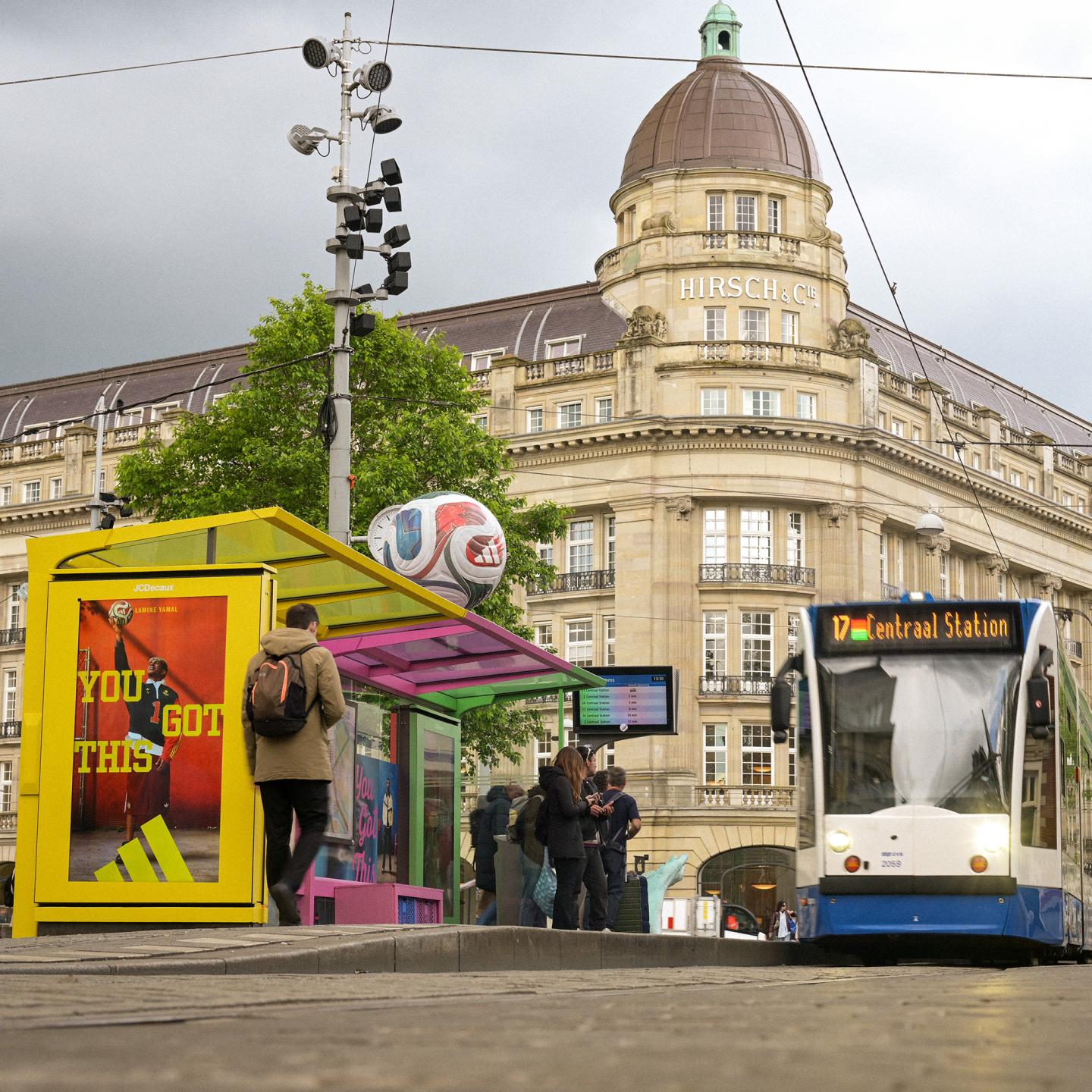 JCDecaux bus shelter in Amsterdam transformed into a World Cup training installation with colourful adidas panels and equipment crates.
