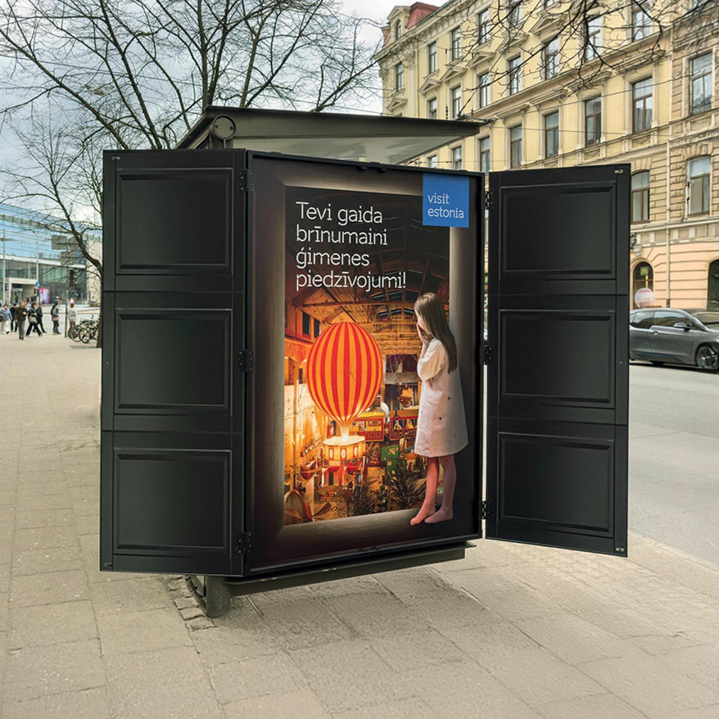 Close-up of the Narnia-inspired wardrobe integrated into a JCDecaux bus shelter, inviting passers-by to discover Estonia through an immersive experience