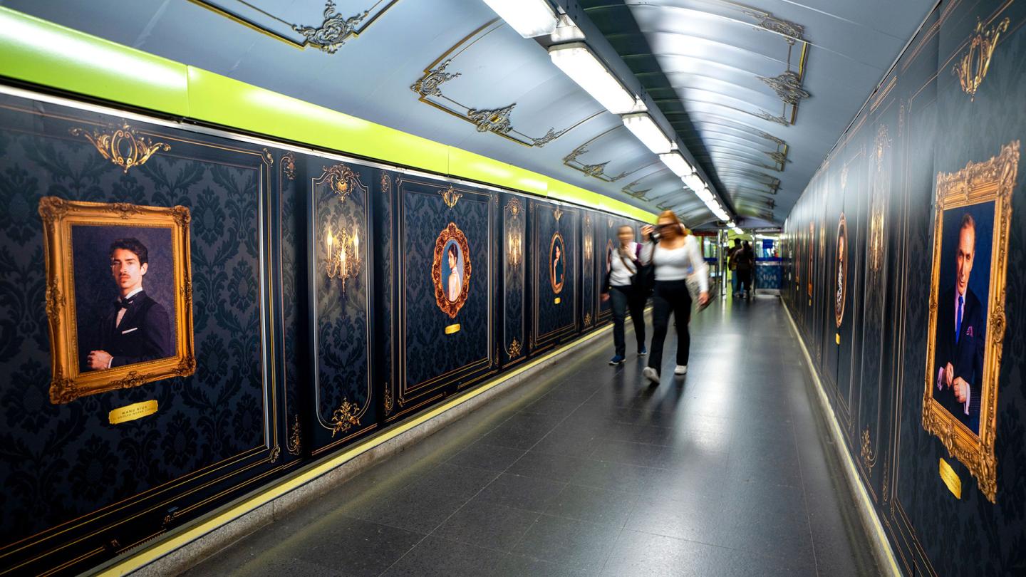 Wide shot of the Madrid Metro platform featuring a total advertising takeover.