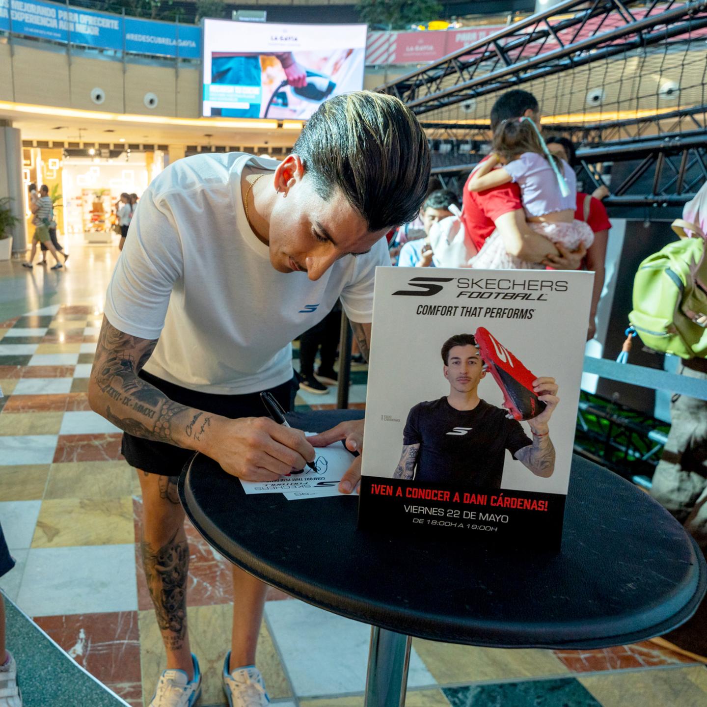 Campaign ambassador Dani Cárdenas signing autographs for fans at the Skechers football event in Madrid