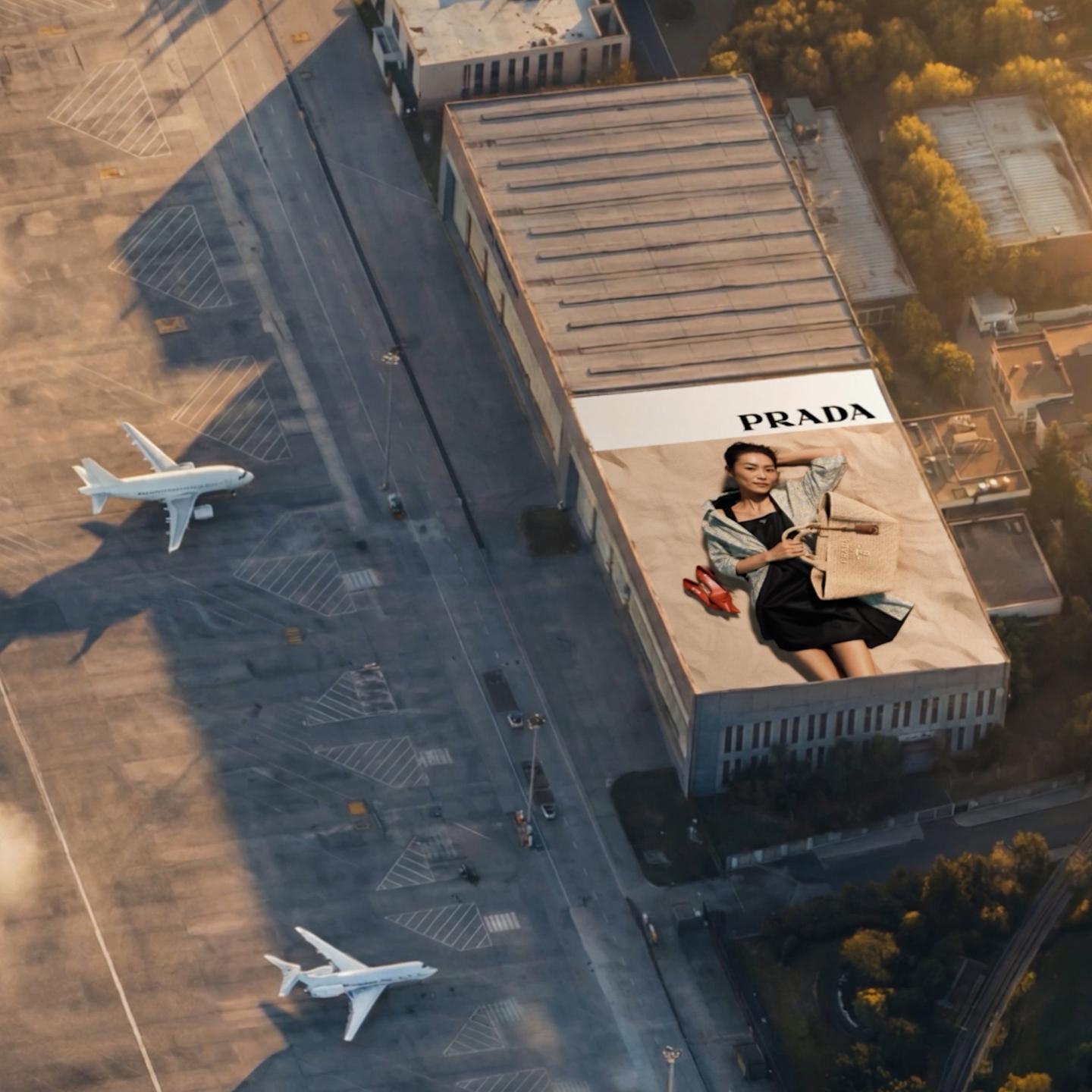 High-net-worth travellers walking on the private jet apron at Shanghai Hongqiao Airport FBO with the large-format SAMDecaux Prada “Days of Summer 2026” campaign visible in the background.