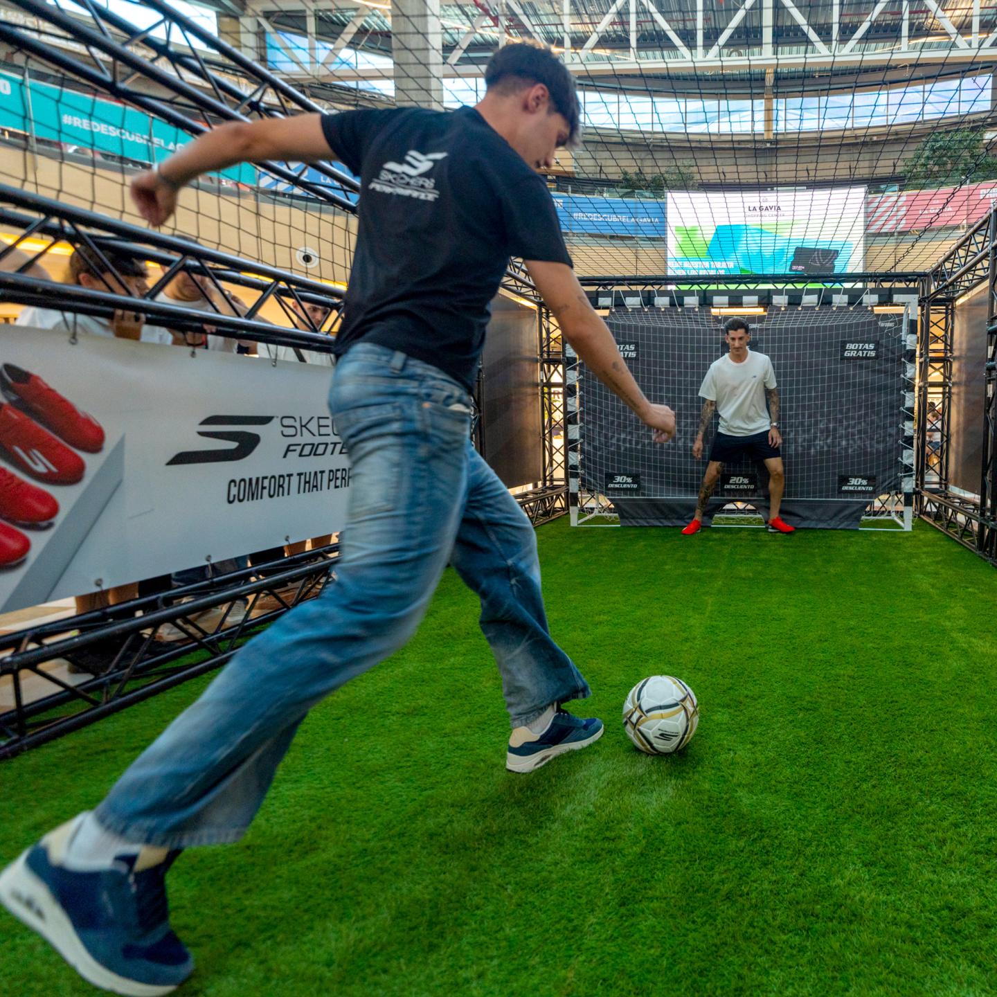 Detail shot of a participant preparing to shoot a penalty against the Skechers branded goal in the mall