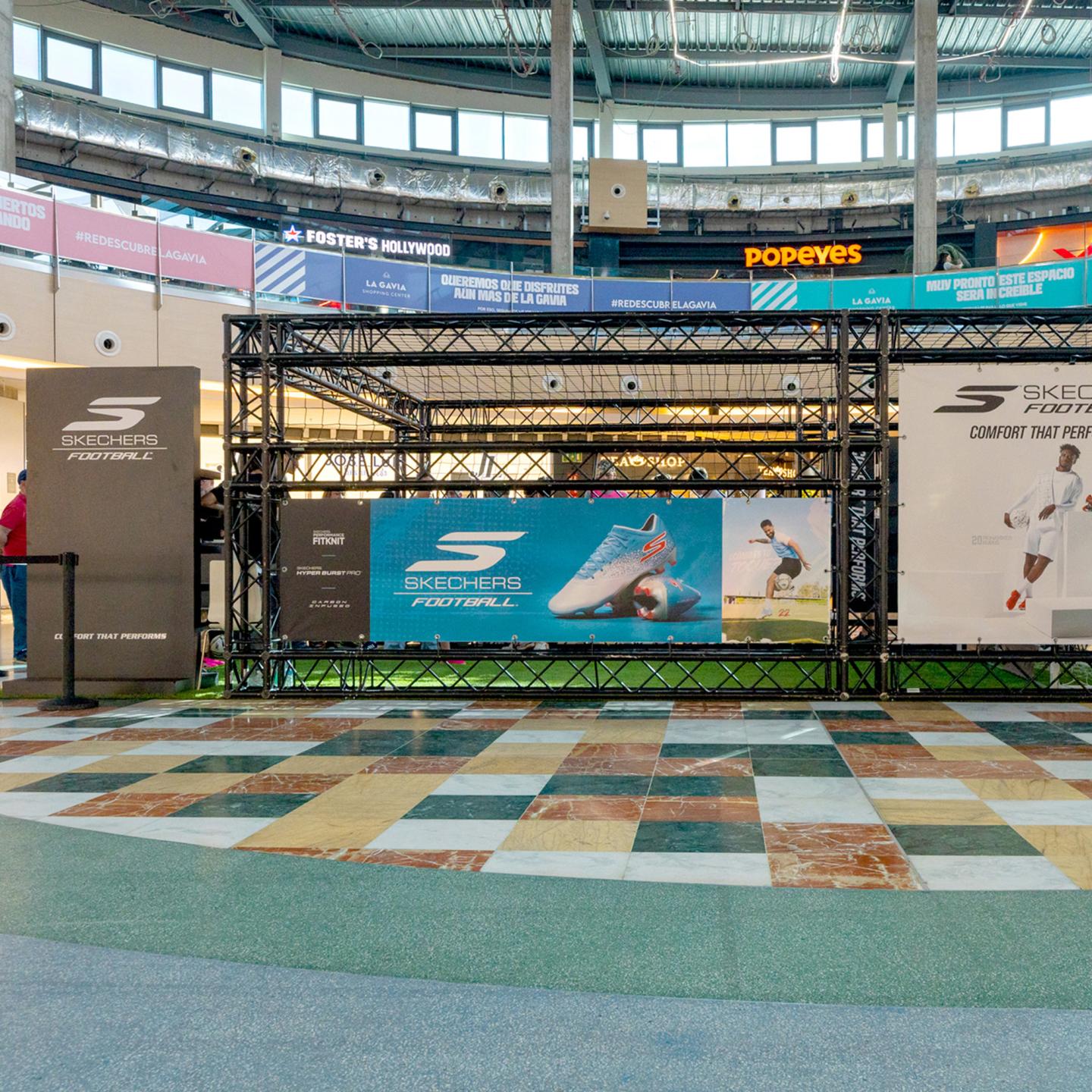 Wide view of the Skechers branded football cage and artificial turf pitch installed in La Gavia mall