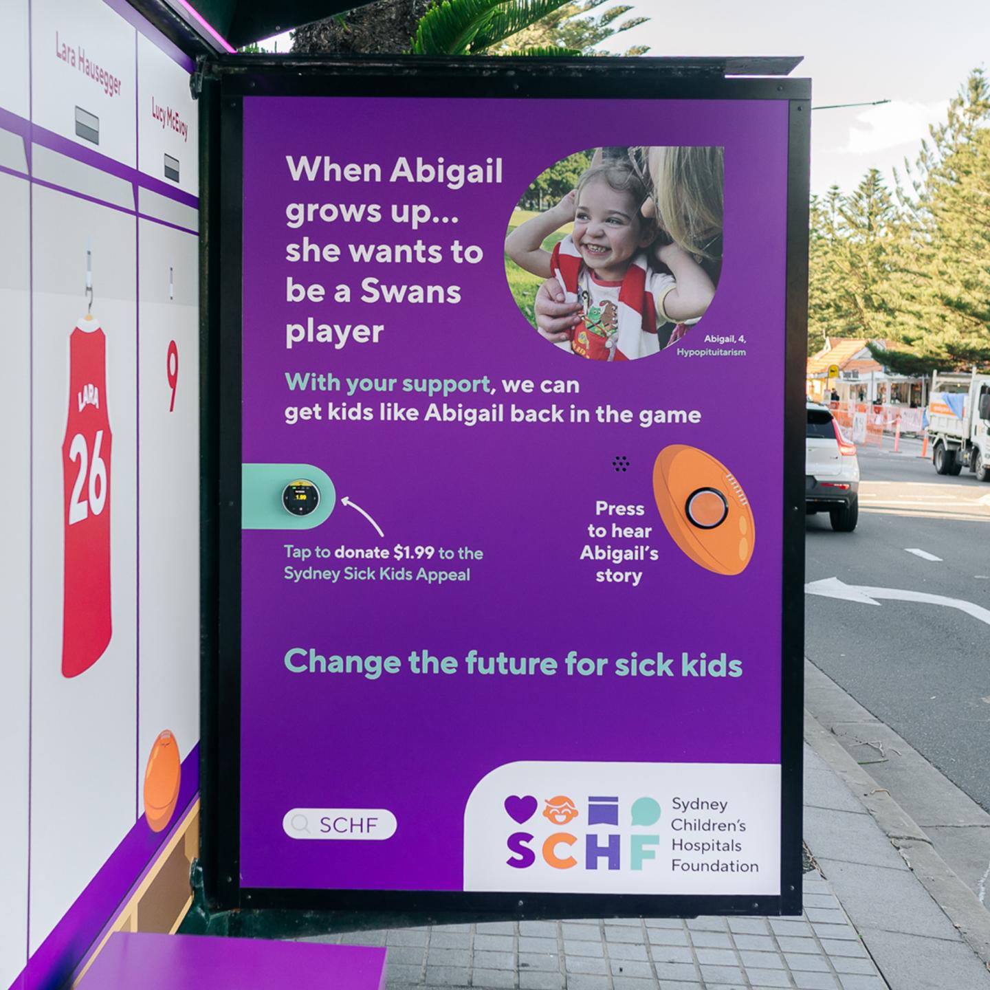 Full view of immersive charity bus shelter with purple flooring, benches and hospital‑themed visuals.