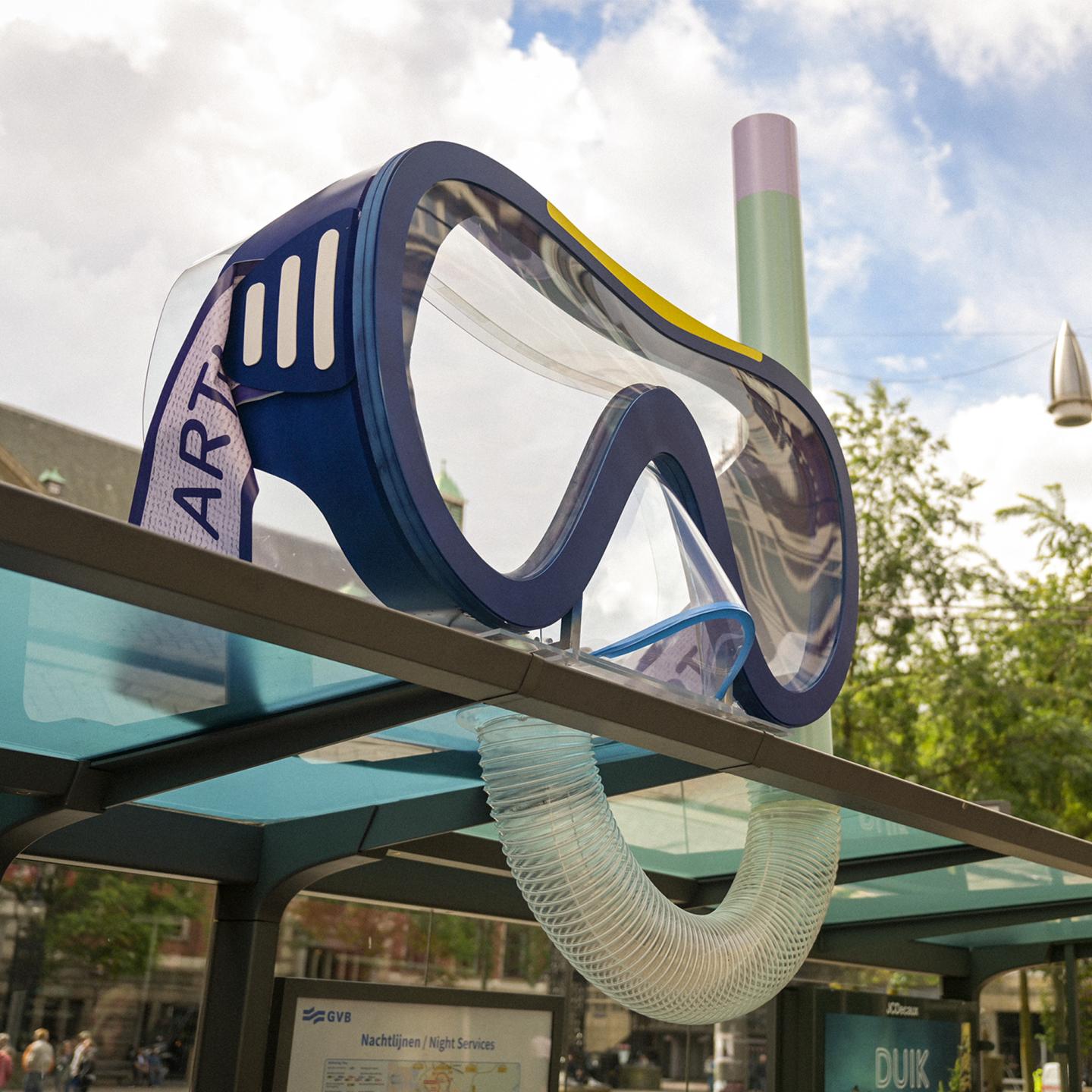 Close‑up of a giant diving mask installed by JCDecaux on top of a tram shelter, symbolising an underwater dive into the Artis aquarium.