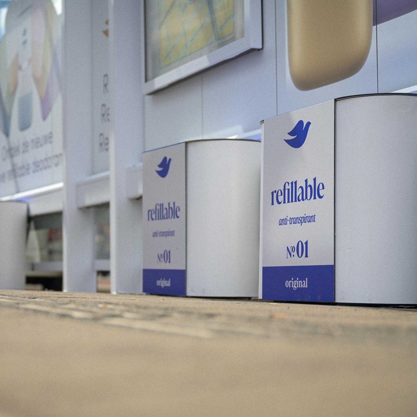 Detail of JCDecaux benches integrated into a Dove deodorant refill installation, showing 3D‑printed components and clean white branding.