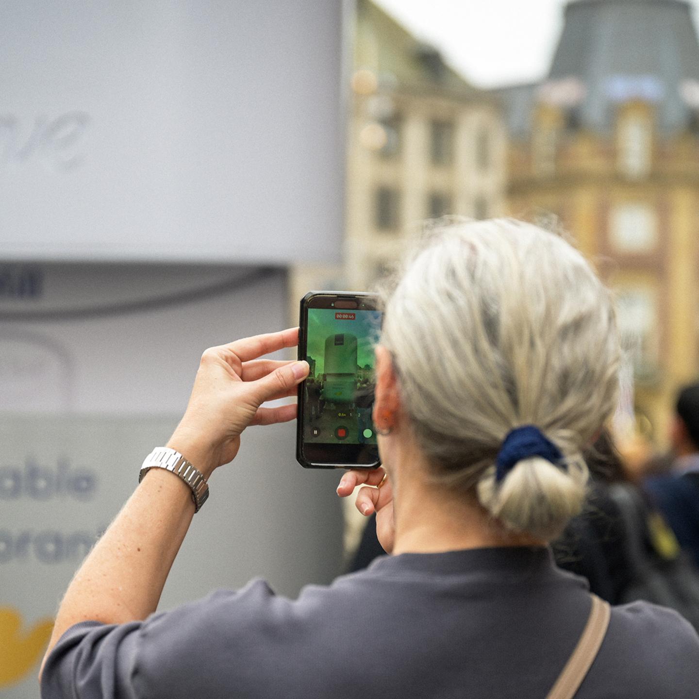 Giant Dove refillable deodorant structure by JCDecaux standing in a crowded Amsterdam square, acting as a striking urban landmark.