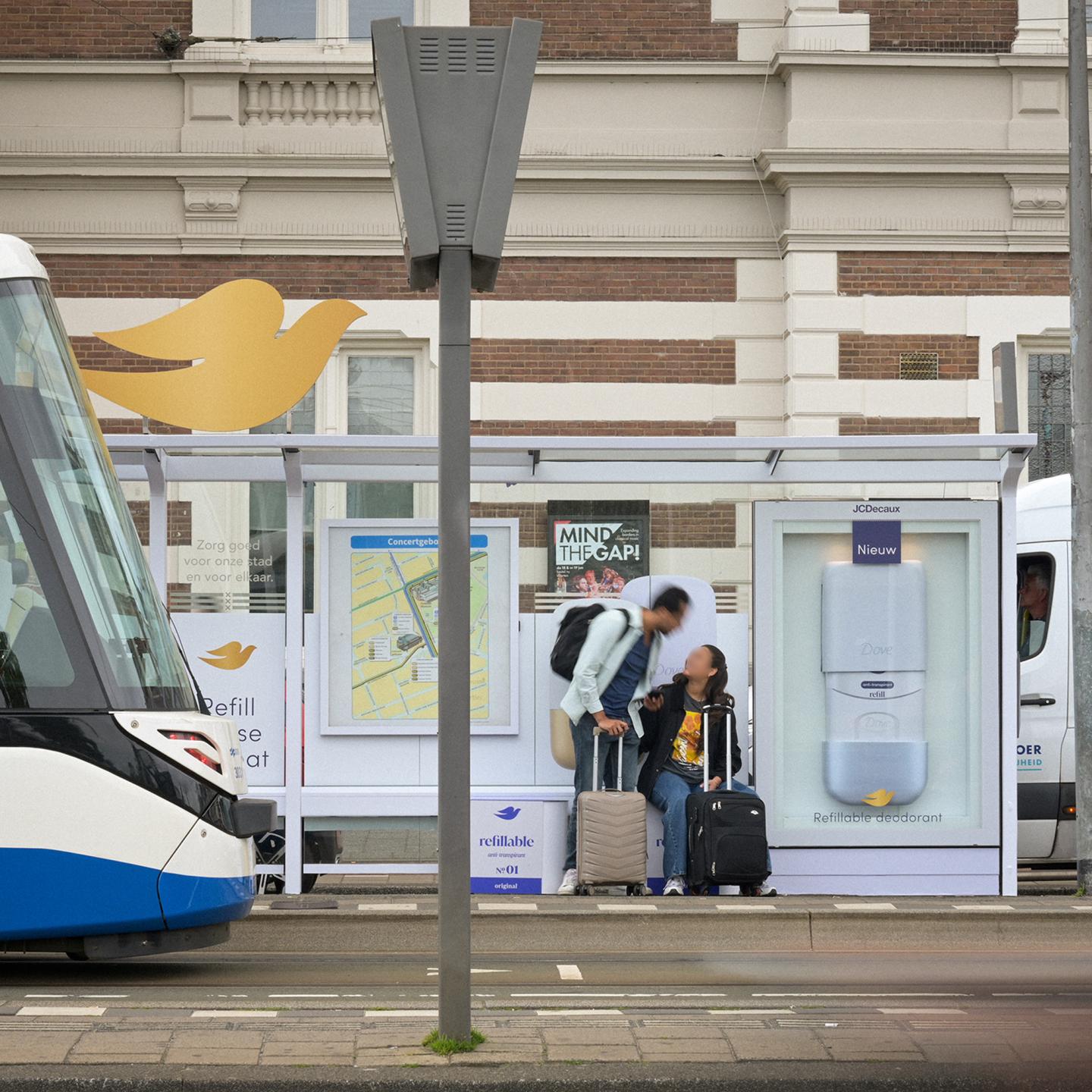 JCDecaux tram shelter in Amsterdam redesigned as a giant Dove refillable deodorant, with 3D‑printed panels and branding visible along the platform.