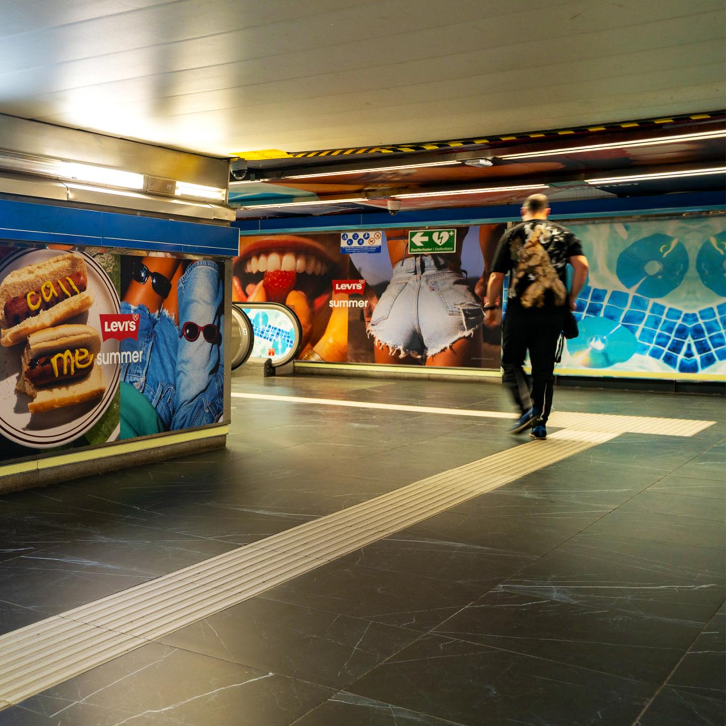 Metro passengers immersed in a full denim‑themed environment at Tribunal station, with Levi’s branding managed by JCDecaux.