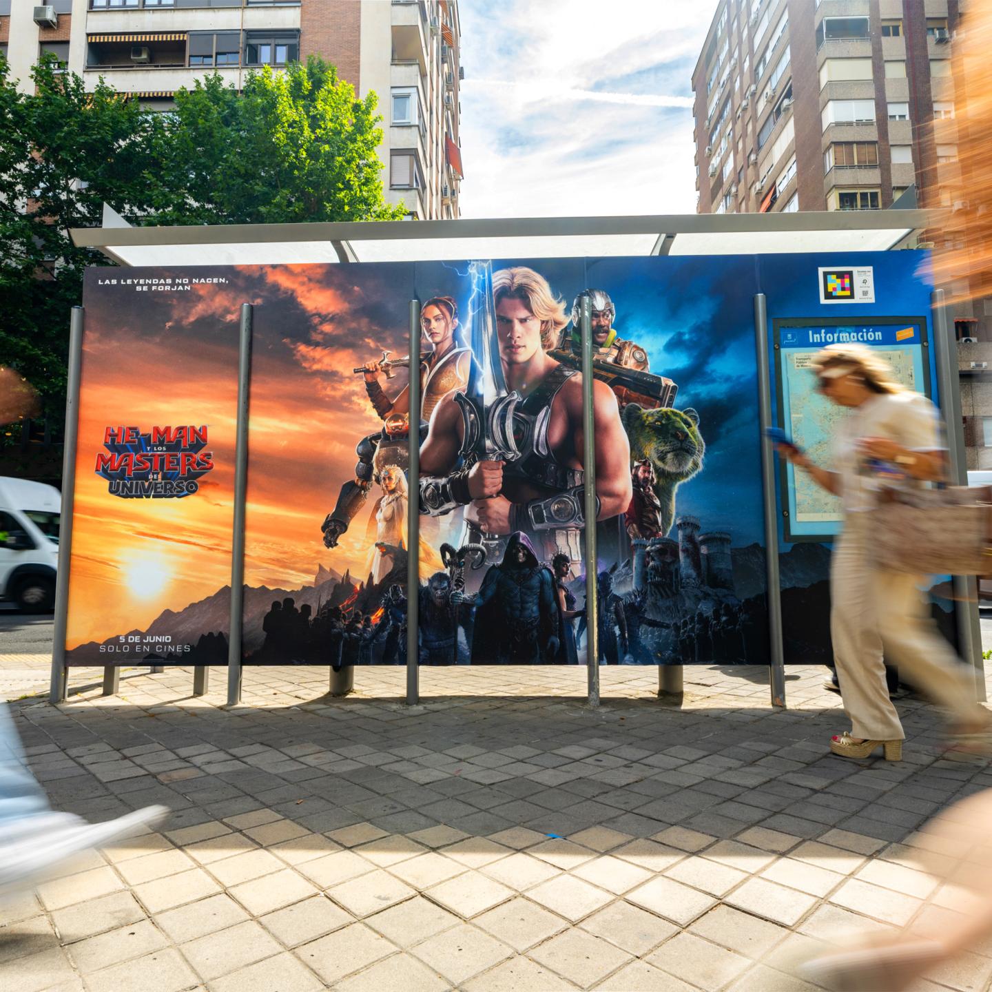 Night view of JCDecaux bus shelter in Madrid turned into an immersive Masters of the Universe installation with illuminated Power Sword.