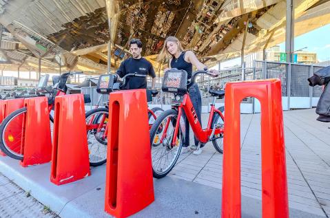 Una pareja se prepara para tomar dos bicicletas de Bicing en Barcelona.
