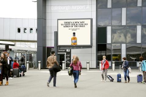 a large billboard advertising at Edinburgh Airport