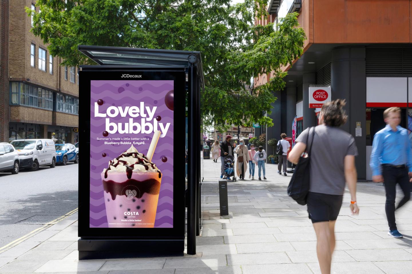 A Digital Out-of-Home advertising billboard from Costa displayed on a bus shelter in London