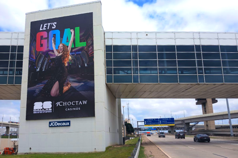 Choctaw advertises with FIFA World Cup creative at Dallas Fort Worth Intl Airport next to the roadway
