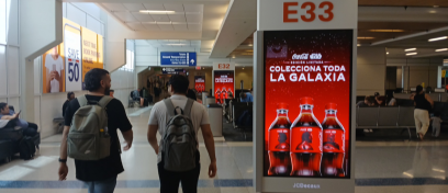 Passengers in DFW airport pass by synched panels of Coca cola advertising their star wars collab