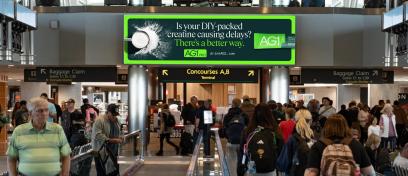 AG1 advertises their new travel ready creatine on DEN digital spectaculars over a busy people mover.