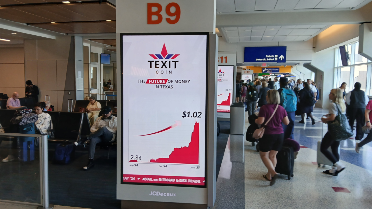 Passengers walk through concourse past PDN screens showing TEXIT ad