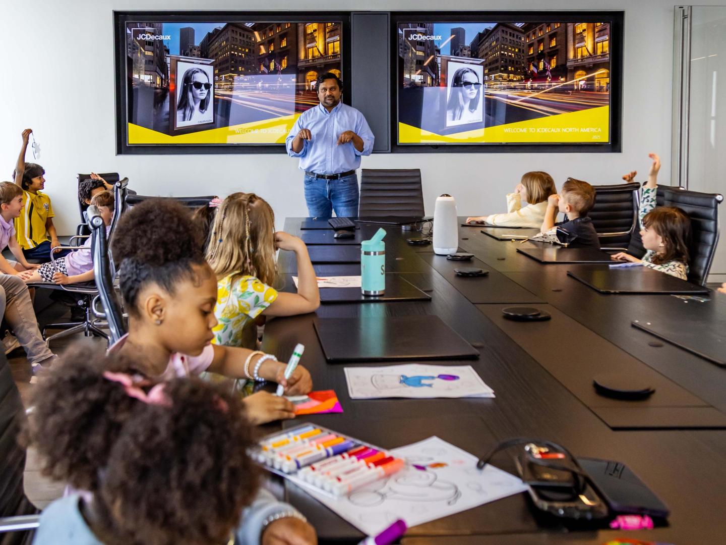 JCDecaux employee Mark Costa presents during Bring Your Kid to Work Day