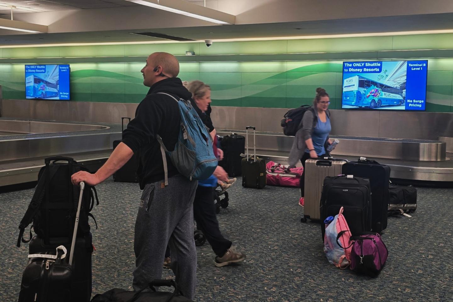 Mears advertises their shuttle service to the parks in Orlando International Airport's baggage claim area