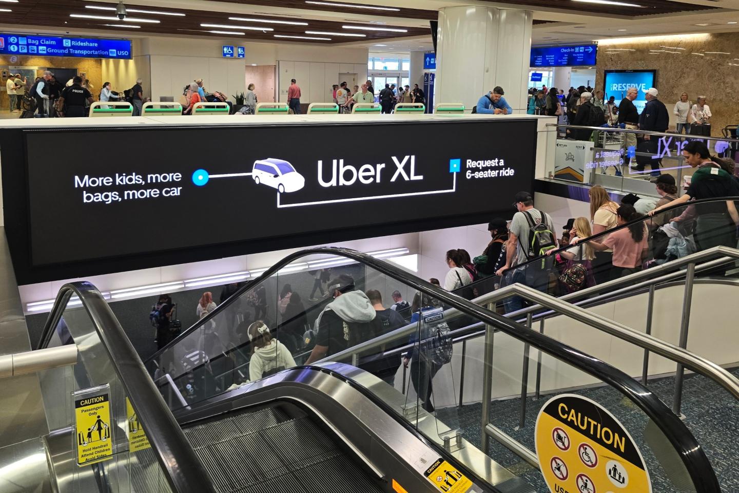 Uber reaches arriving passengers at MCO with their Uber XL messaging on oversized digital spectacular