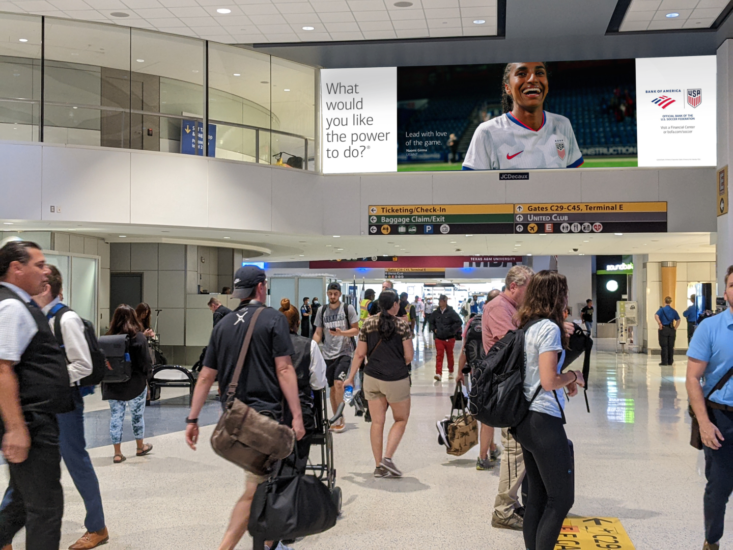 Passengers walk through IAH concourse under Bank of America advertising