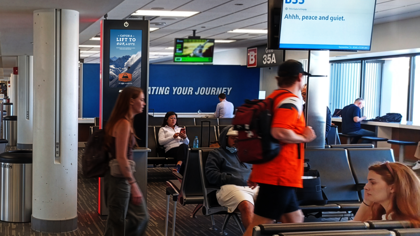 Passengers at Boston Logan International Airport walk past an ad for Mammoth Lakes on their way to their gates